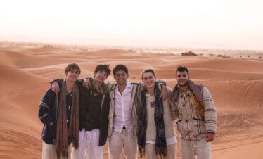 stuends watching the sunset in the golden dunes