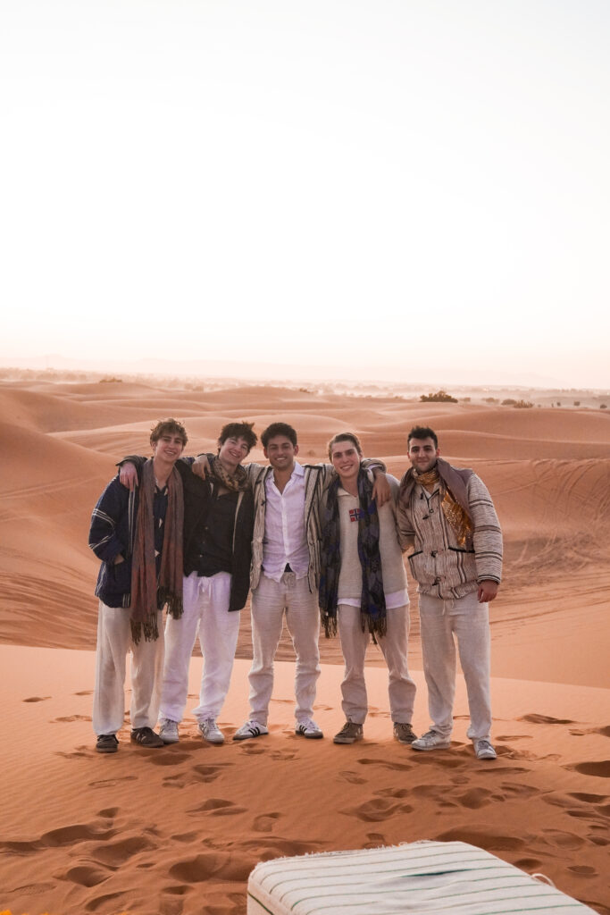stuends watching the sunset in the golden dunes